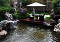喷泉水池景观,景石,木平台,阳伞,桌椅,灌木丛,住宅景观
